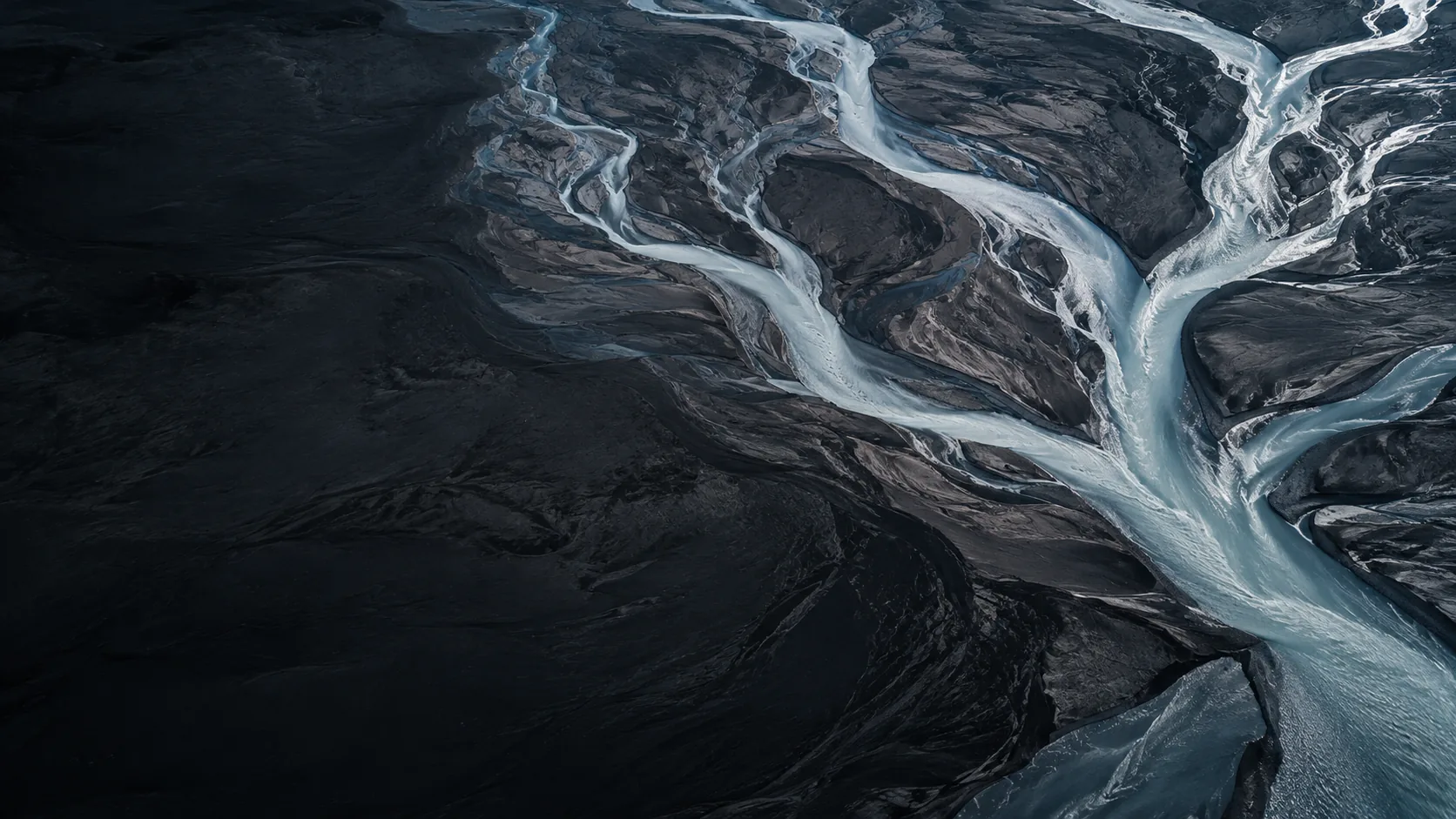 Branching rivers flowing through a dark landscape